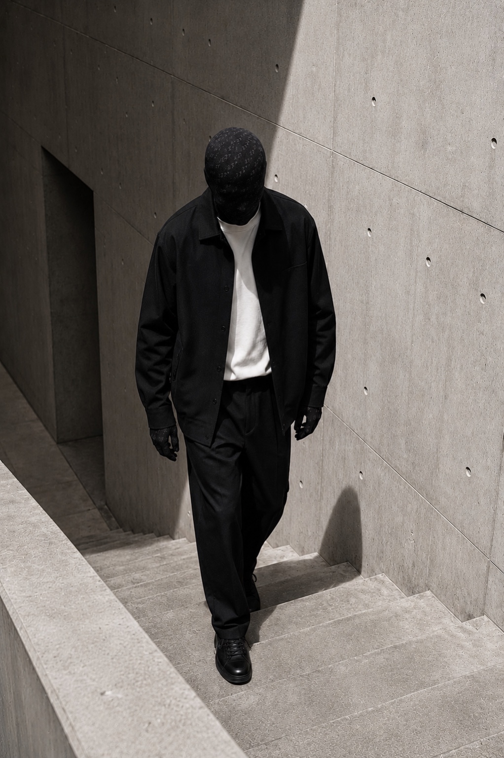 Subject 27 on concrete stairs in the same restrained monochrome world.